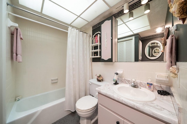 full bathroom with tasteful backsplash, vanity with extensive cabinet space, tile walls, shower / bathtub combination with curtain, and toilet