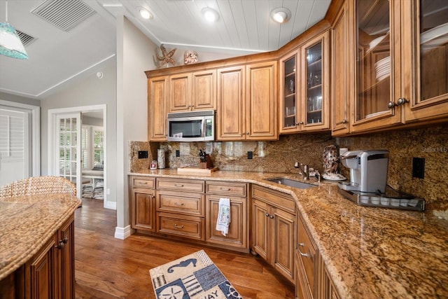 kitchen with sink, dark hardwood / wood-style flooring, and lofted ceiling