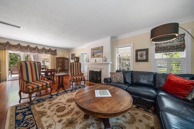 living room featuring ornamental molding and wood-type flooring