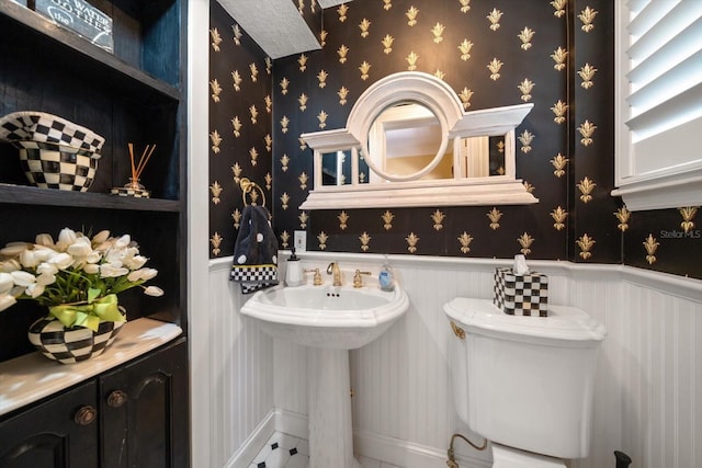 bathroom with tile flooring and toilet