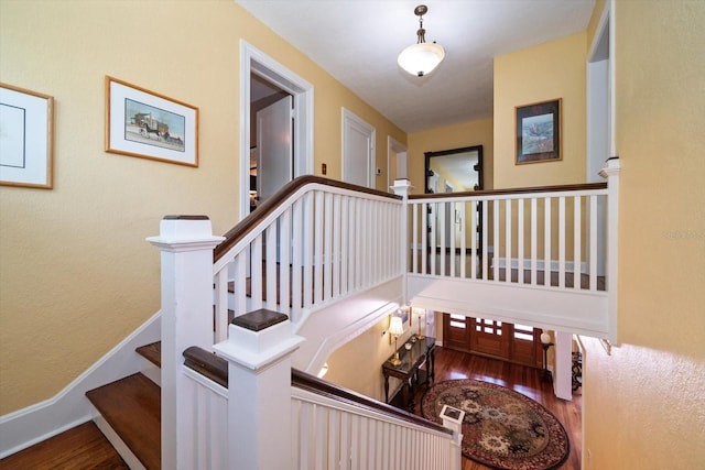 staircase with dark hardwood / wood-style floors