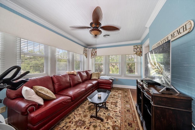 living room featuring a healthy amount of sunlight, crown molding, and hardwood / wood-style flooring