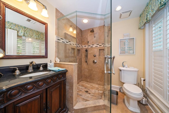 bathroom with tiled shower, tile flooring, oversized vanity, and toilet