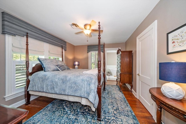 bedroom featuring dark hardwood / wood-style floors, multiple windows, and ceiling fan