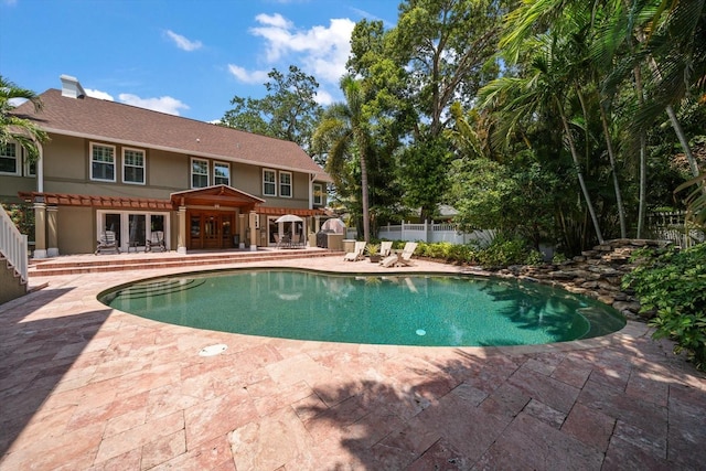 view of pool with a patio and a pergola