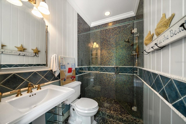 bathroom with tile walls, toilet, crown molding, an enclosed shower, and sink