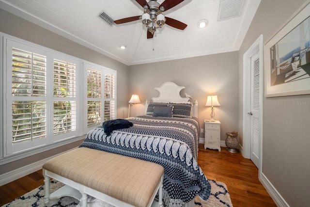 bedroom with ornamental molding, ceiling fan, dark hardwood / wood-style floors, and lofted ceiling