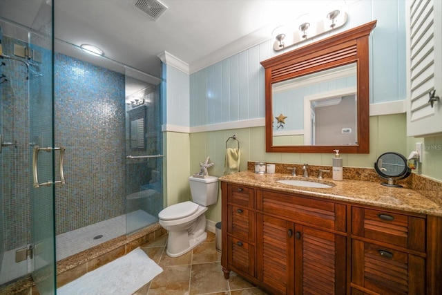 bathroom with ornamental molding, tile floors, a shower with door, large vanity, and toilet