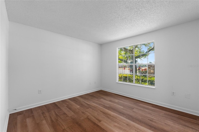 empty room featuring hardwood / wood-style floors and a textured ceiling