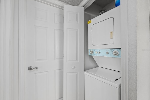 washroom with stacked washer and clothes dryer