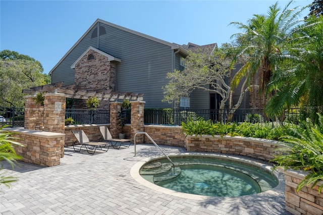 view of pool featuring a hot tub and a patio area