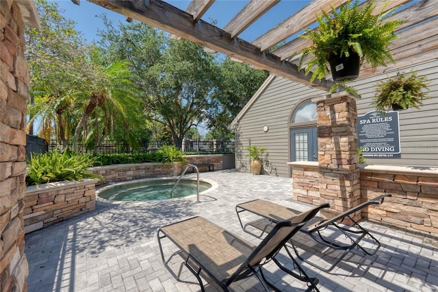 view of patio / terrace with a community hot tub and a pergola