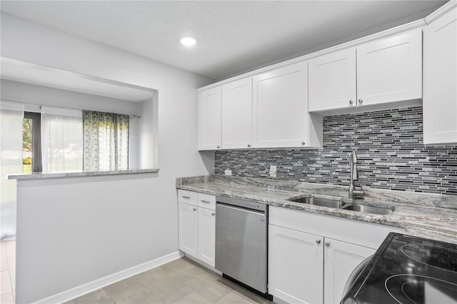 kitchen featuring dishwasher, sink, white cabinetry, and light stone countertops