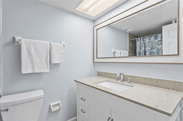 bathroom featuring oversized vanity and toilet