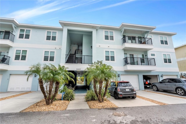 view of front of home featuring a balcony and a garage