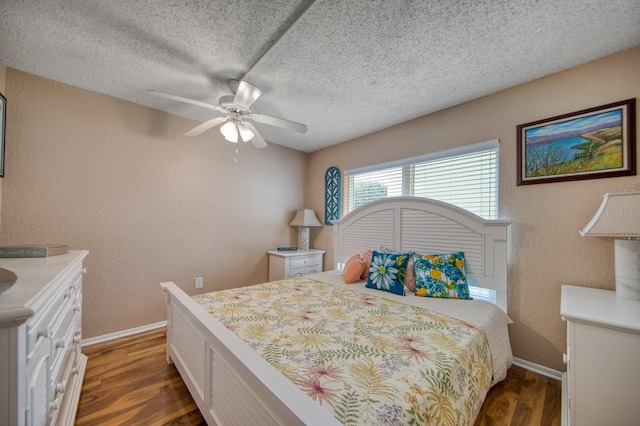 bedroom with a textured ceiling, wood-type flooring, and ceiling fan