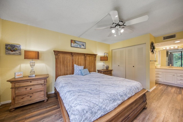 bedroom featuring ceiling fan, a closet, wood-type flooring, sink, and connected bathroom