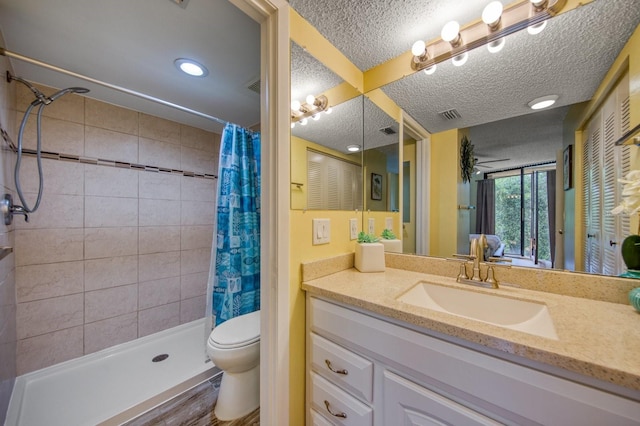 bathroom with hardwood / wood-style flooring, toilet, large vanity, walk in shower, and a textured ceiling