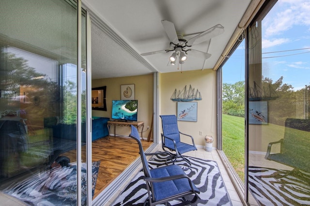 sunroom featuring a healthy amount of sunlight and ceiling fan