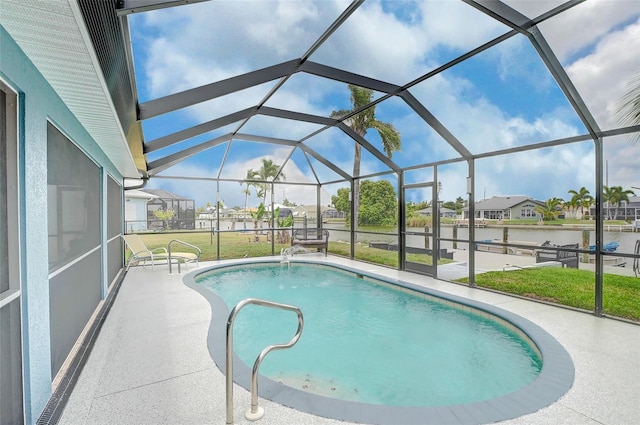 view of pool featuring a patio, glass enclosure, and a yard