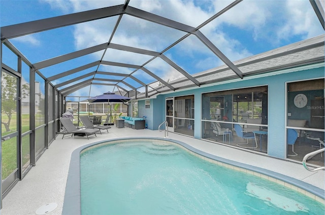 view of pool with a patio area and glass enclosure