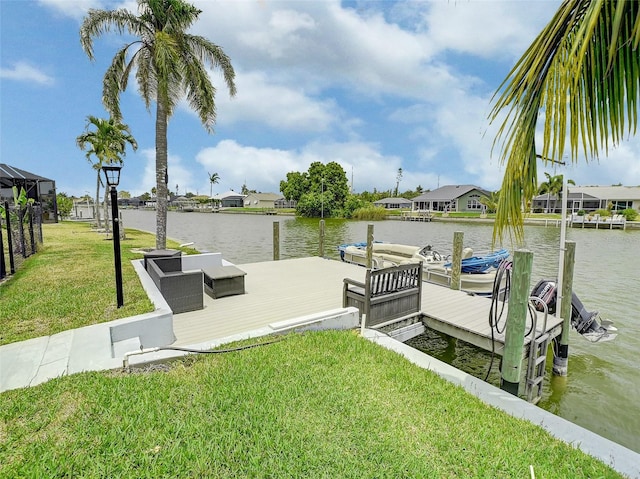 view of dock with a water view and a lawn