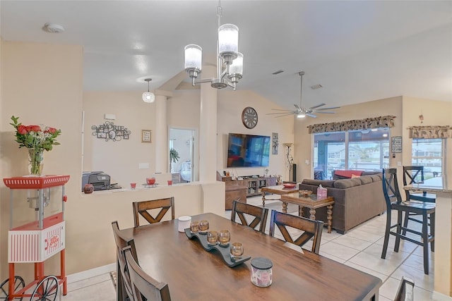 tiled dining room with vaulted ceiling and ceiling fan with notable chandelier