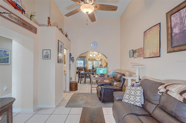 living room with high vaulted ceiling, ceiling fan, and light tile floors