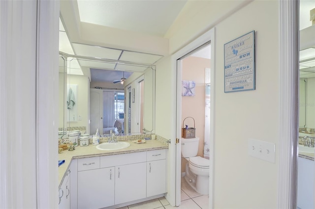 bathroom with tile flooring, vanity, and toilet