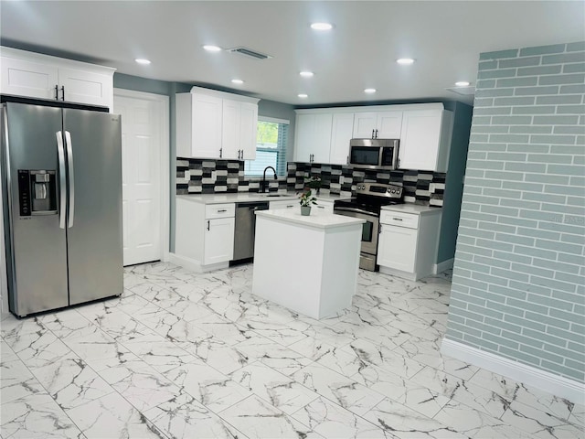 kitchen with tasteful backsplash, a center island, appliances with stainless steel finishes, sink, and light tile floors