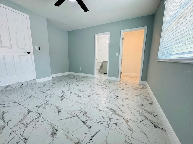 unfurnished bedroom with ensuite bath, ceiling fan, and light tile floors