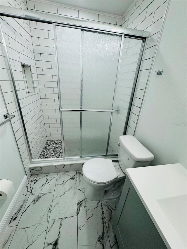 bathroom with an enclosed shower, vanity, toilet, and tile floors