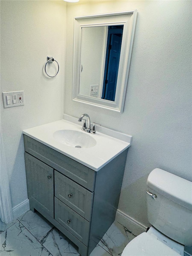 bathroom with tile flooring, vanity, and toilet