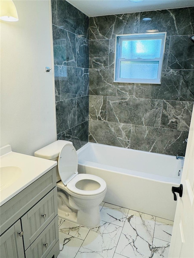 full bathroom with tile walls, toilet, tile floors, tiled shower / bath, and vanity