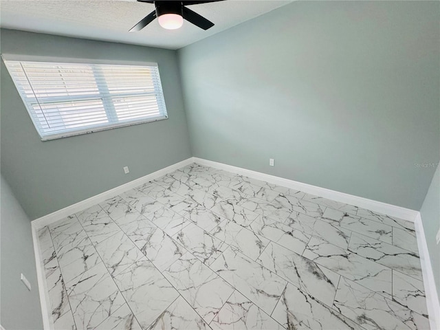 empty room with ceiling fan and light tile floors