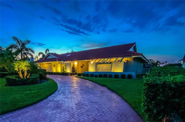 mediterranean / spanish house featuring a lawn