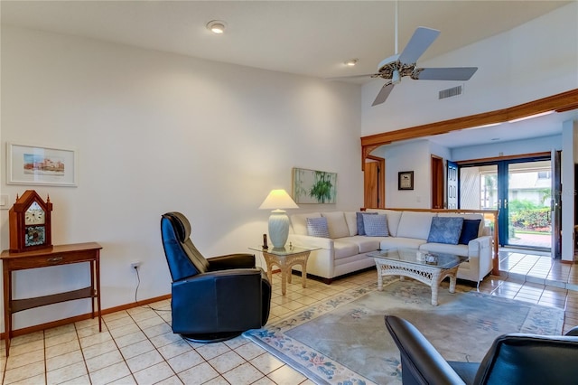 tiled living room with ceiling fan and french doors