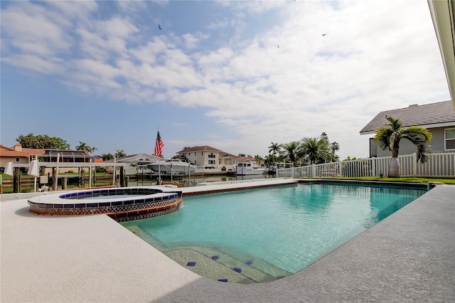 view of swimming pool with an in ground hot tub