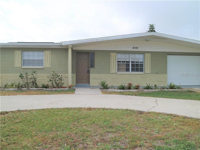 view of front of home with a garage and a front lawn