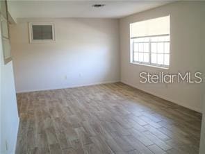 spare room featuring wood-type flooring