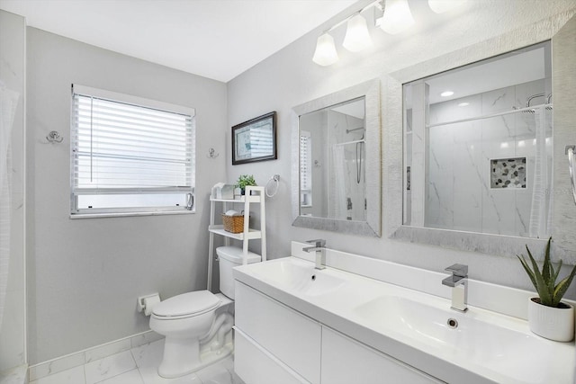 bathroom featuring toilet, vanity, and a shower with shower door