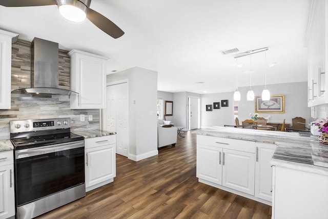 kitchen featuring stainless steel range with electric cooktop, white cabinetry, wall chimney exhaust hood, light stone countertops, and pendant lighting