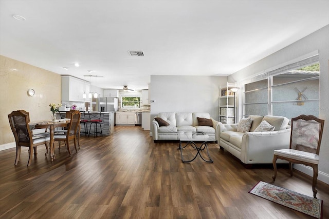 living room with ceiling fan and dark hardwood / wood-style floors