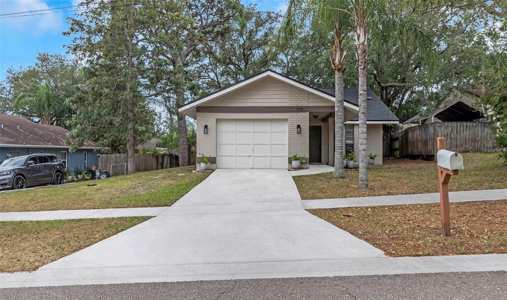 view of front facade with a front yard and a garage