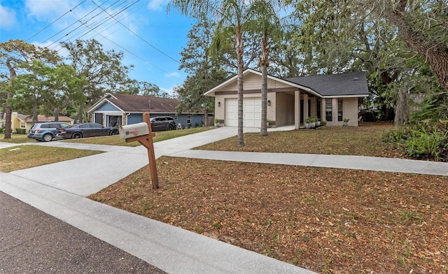 view of front of property with a front yard and a garage