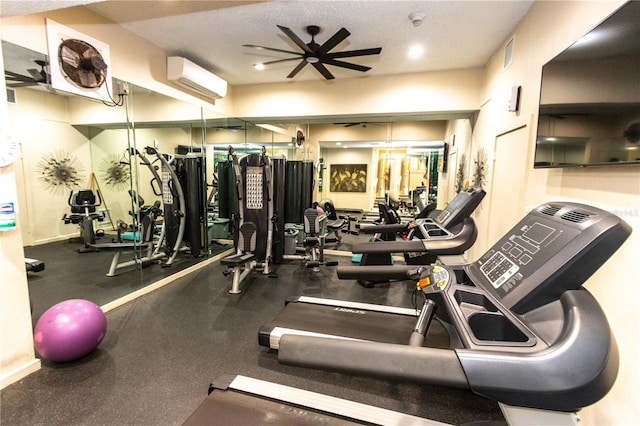 gym featuring a wall mounted AC and ceiling fan