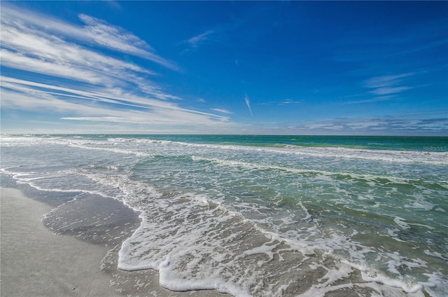 drone / aerial view featuring a water view and a beach view