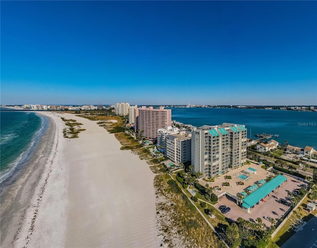 aerial view with a water view and a beach view