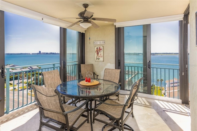 balcony with a water view and ceiling fan