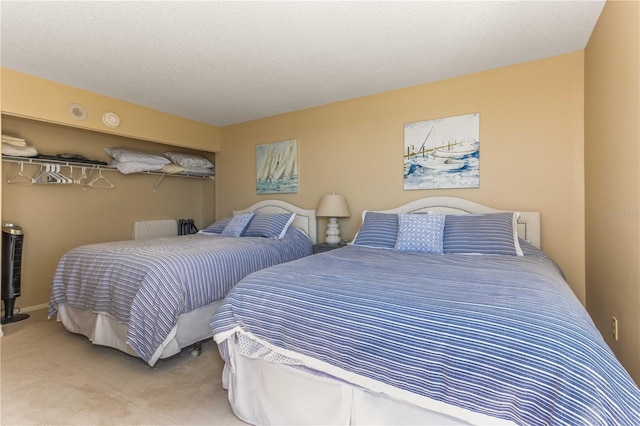 bedroom with carpet floors and a textured ceiling